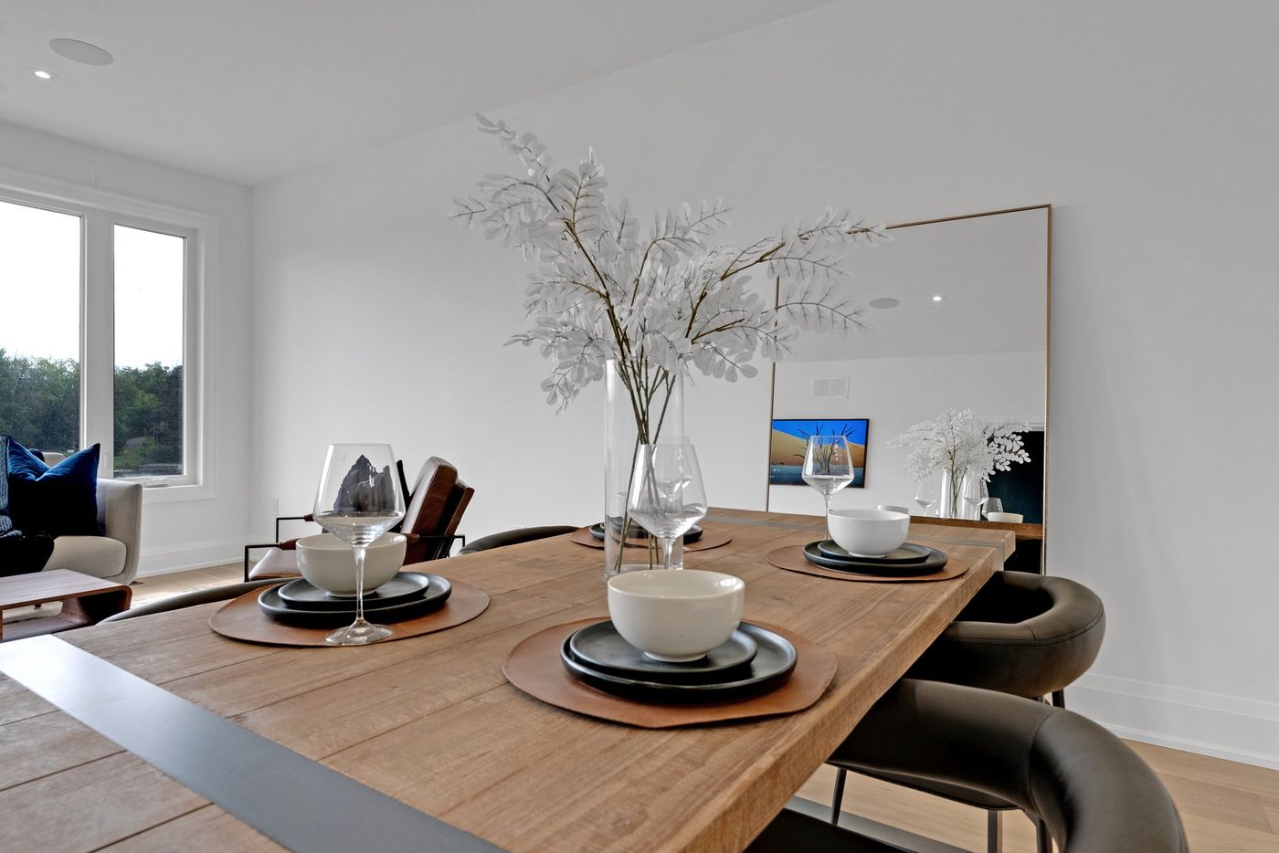 Dining table set for four beside the living room
